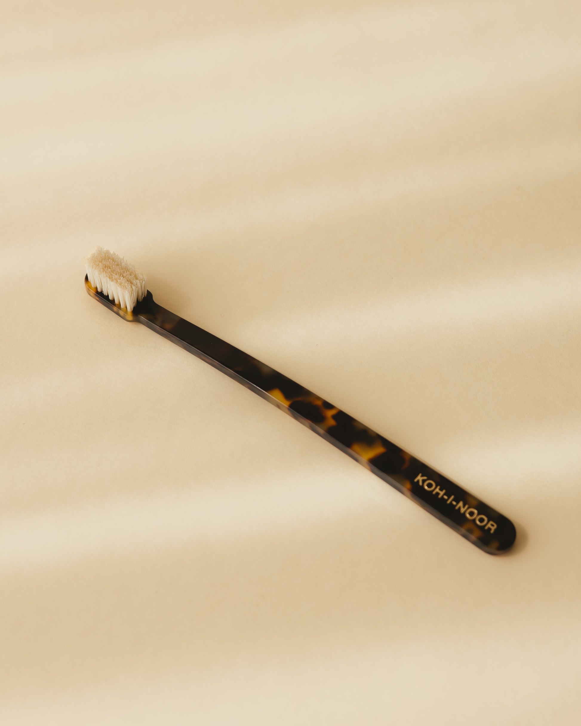 A Koh-i-Noor coccola toothbrush in garden green colour, cellulose acetate.