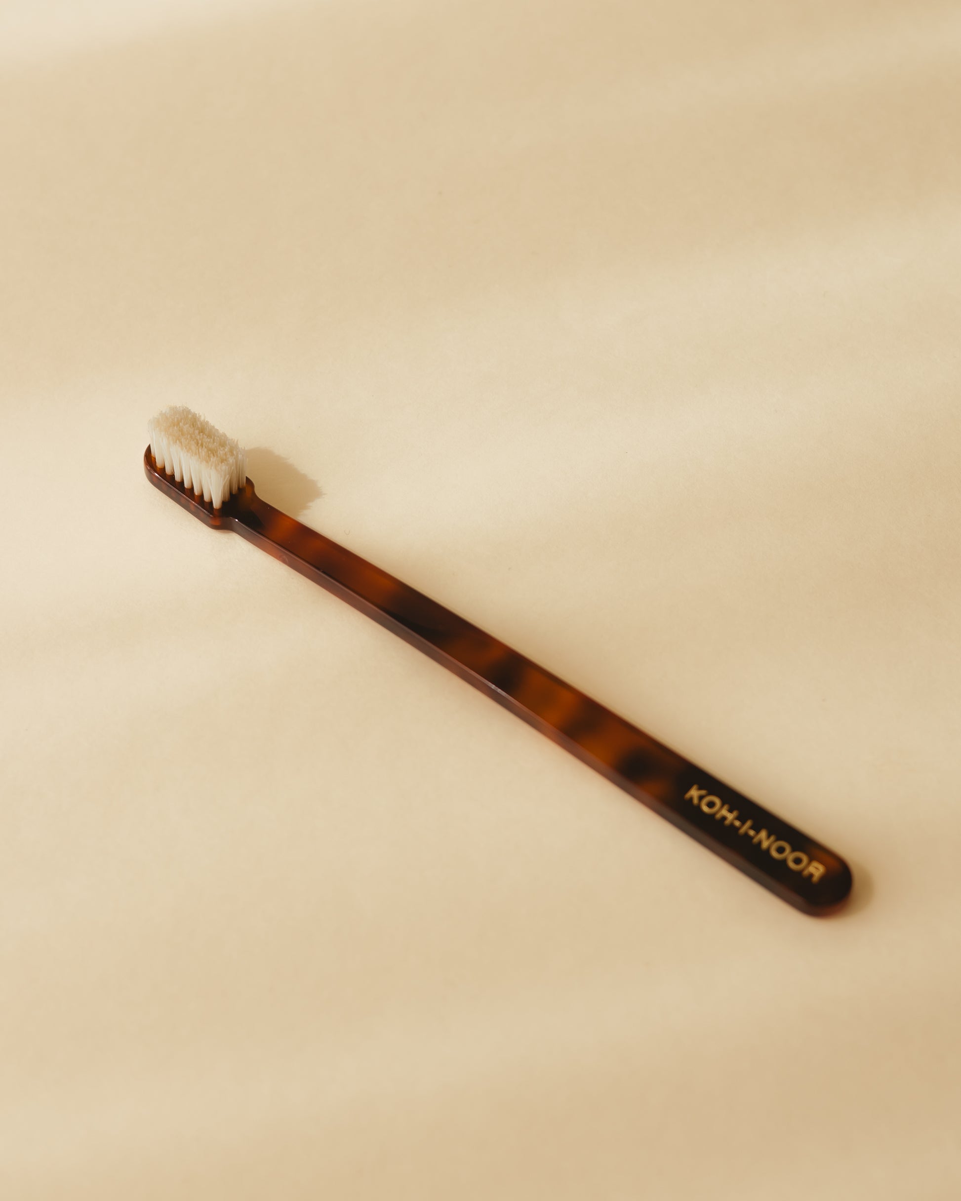 A Koh-i-Noor coccola toothbrush in classic tortoiseshell colour, cellulose acetate.