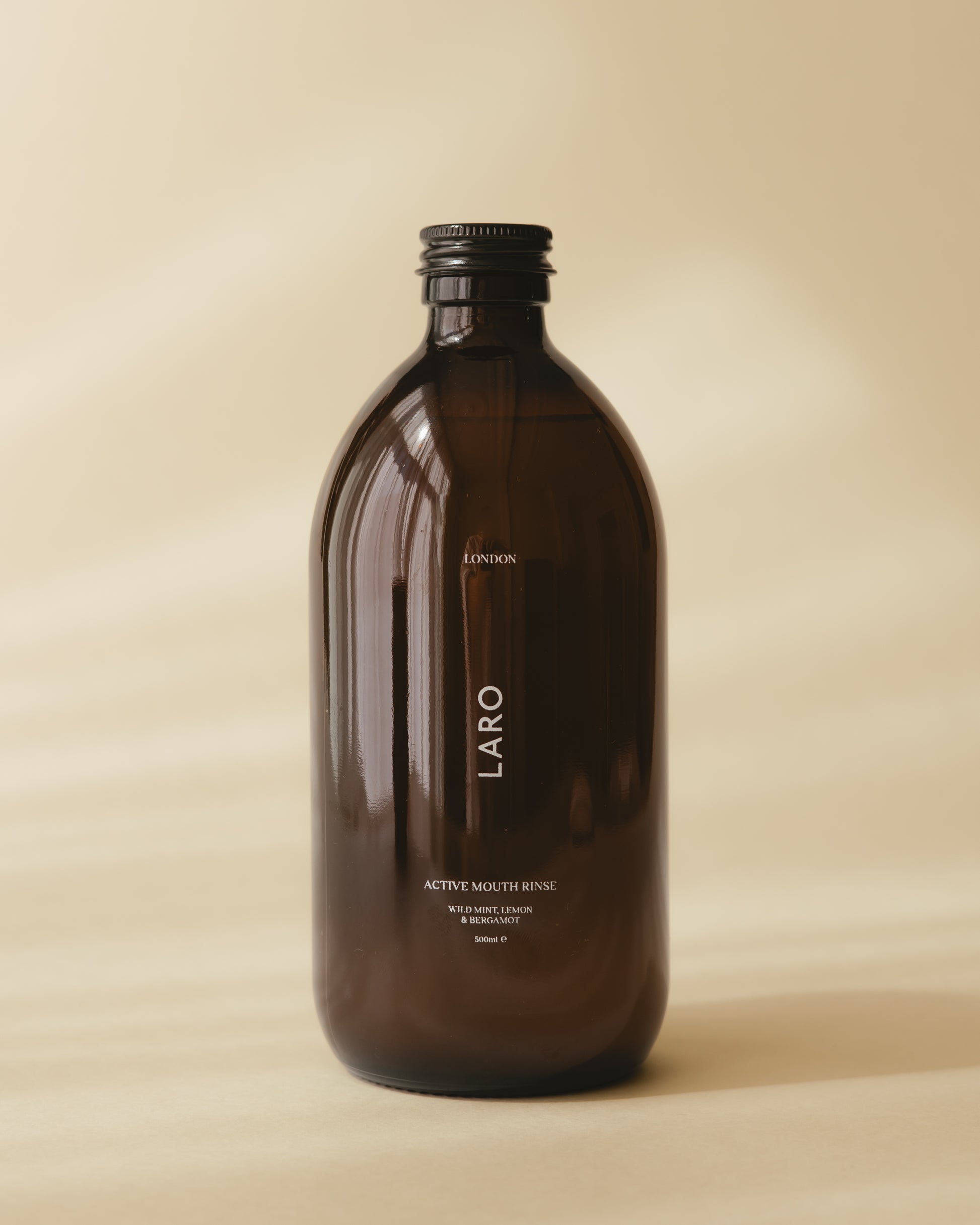 Laro's signature dark amber glass Active Mouth Rinse bottle in wild mint, lemon and bergamot 500ml.
