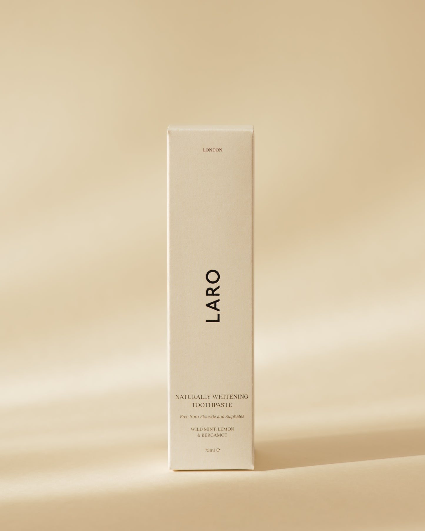 Close-up of Laro's Naturally Whitening Toothpaste product packaging, SLS and fluoride free - wild mint, lemon and bergamot flavour.