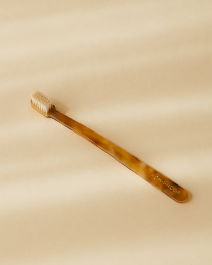 A Koh-i-Noor coccola toothbrush in honey yellow colour, cellulose acetate. 
