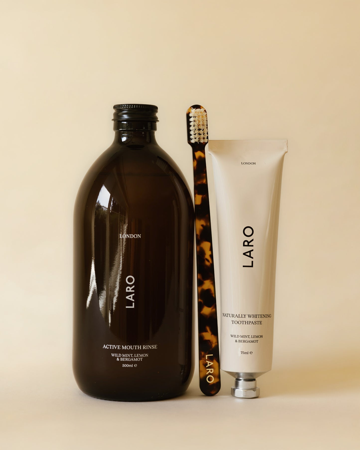 Laro dental care products including mouth rinse, toothpaste, and toothbrush on a beige background