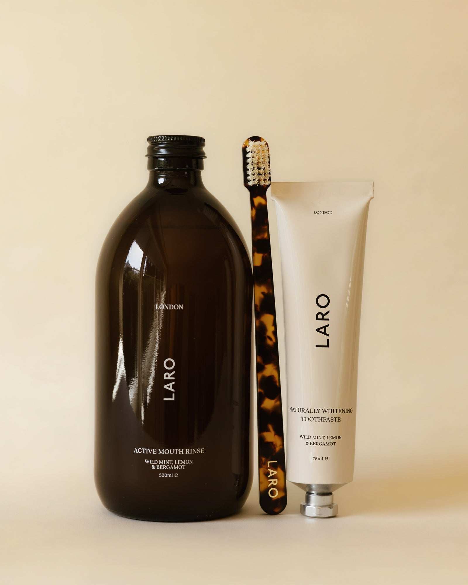 Laro dental care products including mouth rinse, toothpaste, and toothbrush on a beige background