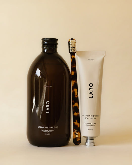 Laro dental care products including mouth rinse, toothpaste, and toothbrush on a beige background